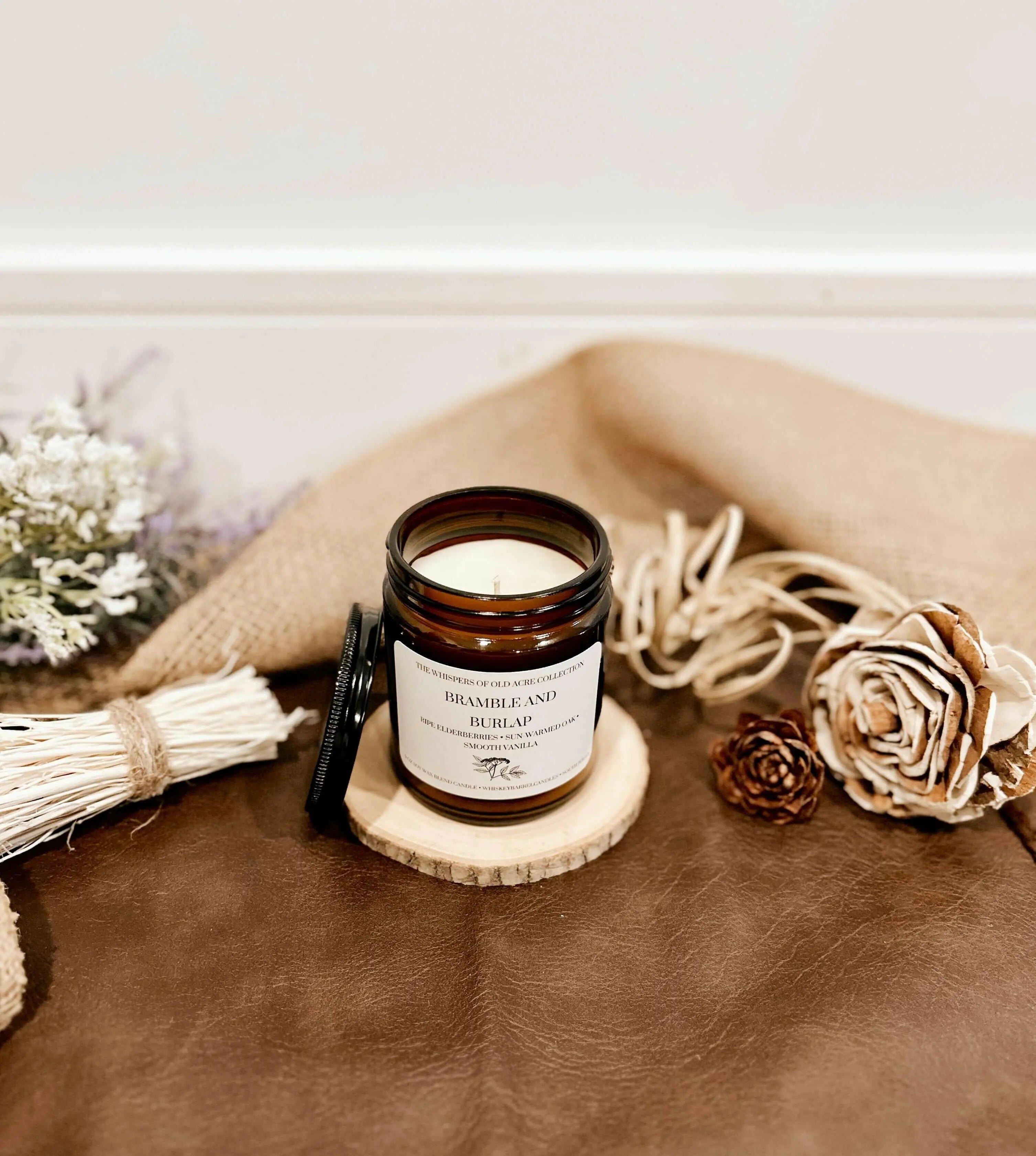 Bramble and Burlap 9oz candle made with soy wax and beeswax:

A basket full of ripe elderberries, hints of sun-warmed oak, and smooth vanilla—just like the wild countryside at the peak of summer’s sweetness.